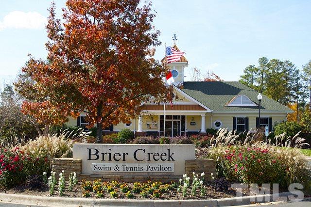 9124 Palm Bay Circle Raleigh, NC 27617 - Photo 3 of 24 a front view of a building with street sign and palm tree