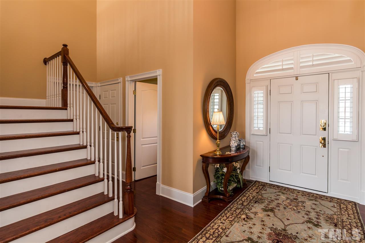 9124 Palm Bay Circle Raleigh, NC 27617 - Photo 4 of 24 a view of a hallway with wooden floor and staircase