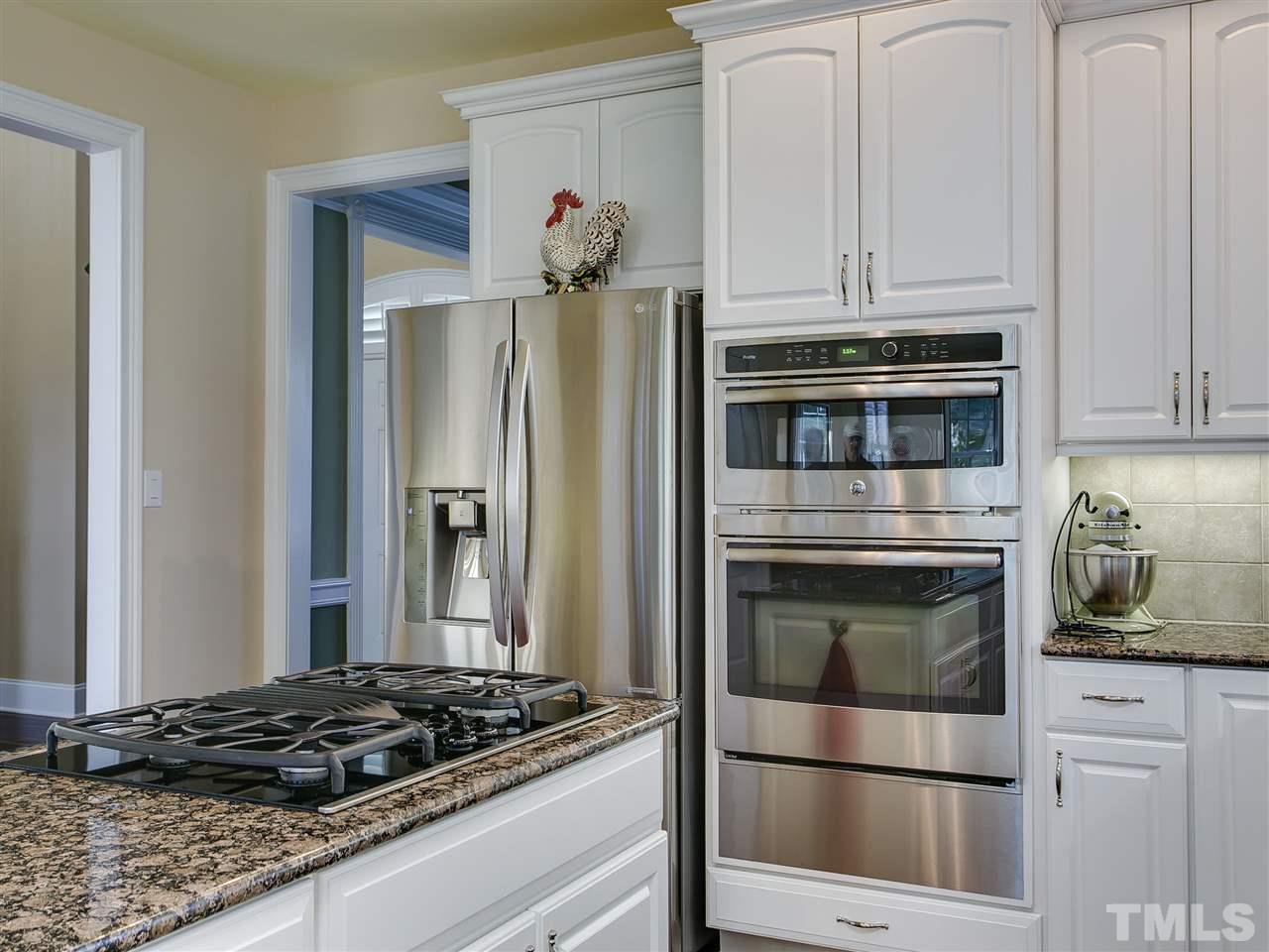 9124 Palm Bay Circle Raleigh, NC 27617 - Photo 8 of 24 a kitchen with granite countertop stainless steel appliances and cabinets