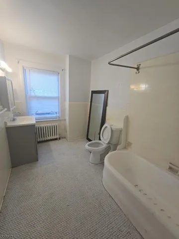 a view of hallway with furniture and wooden floor