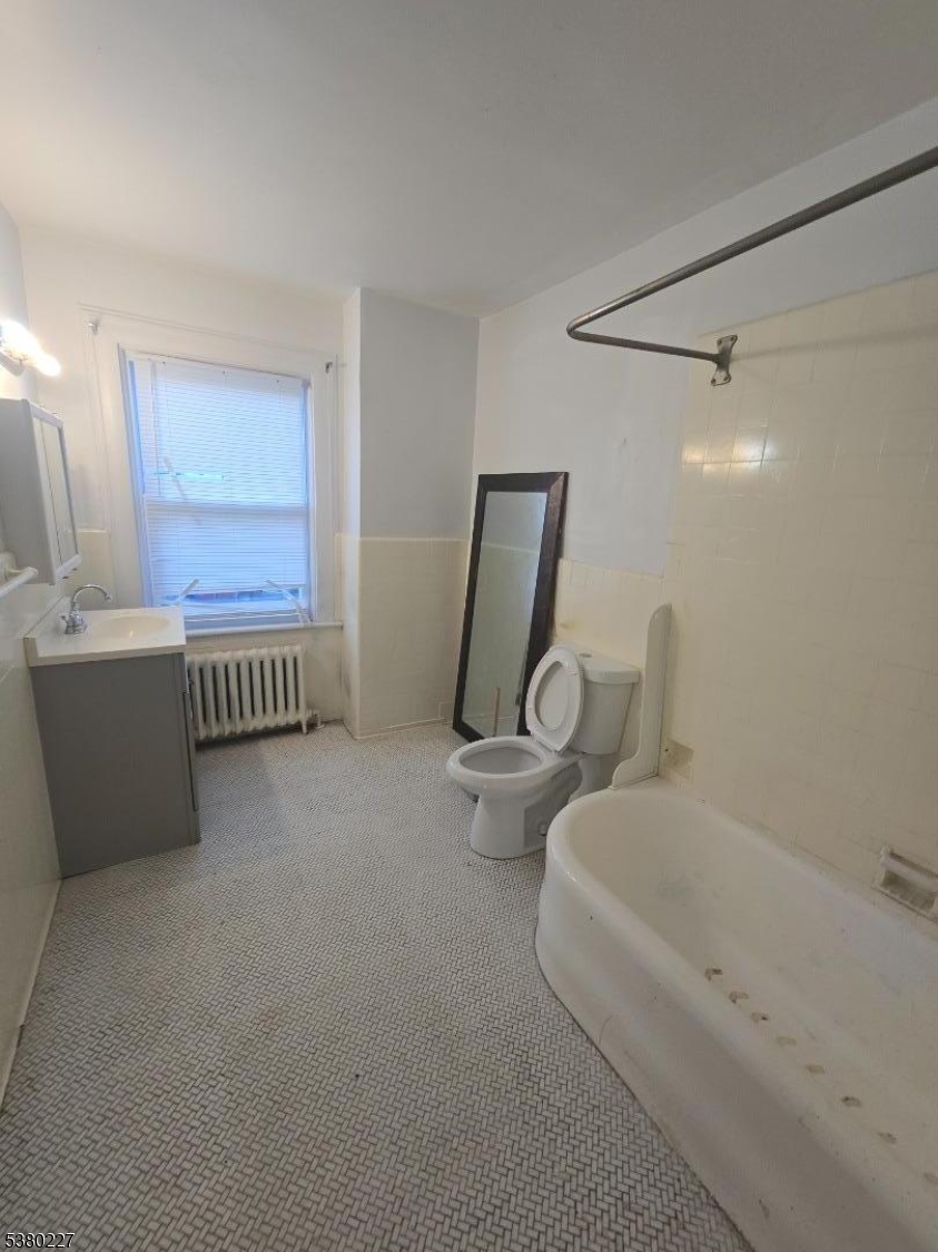 379-387 Mt Prospect Avenue, Unit 4 Newark, NJ 07104 - Photo 12 of 21 a view of a livingroom with lounge chair and windows