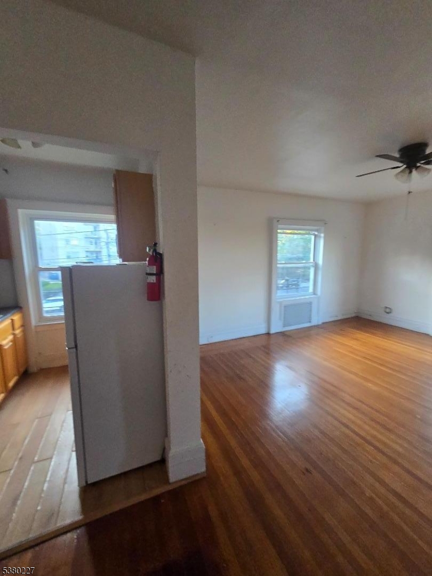 379-387 Mt Prospect Avenue, Unit 4 Newark, NJ 07104 - Photo 13 of 21 an empty room with wooden floor and windows