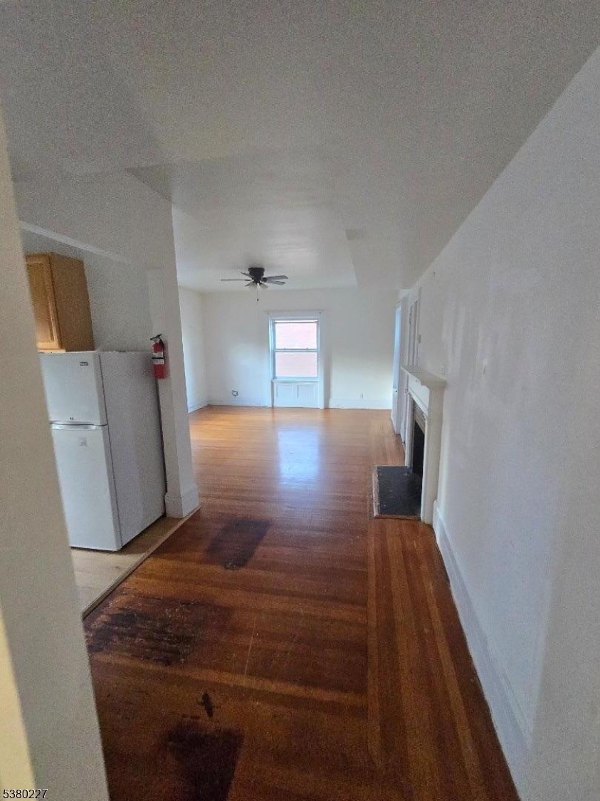 379-387 Mt Prospect Avenue, Unit 4 Newark, NJ 07104 - Photo 14 of 21 a view of hallway with furniture and wooden floor