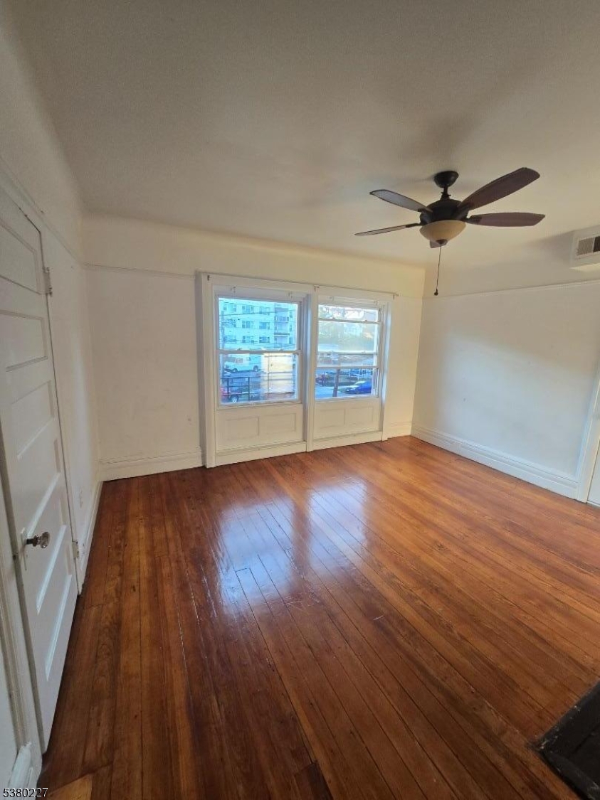 379-387 Mt Prospect Avenue, Unit 4 Newark, NJ 07104 - Photo 20 of 21 wooden floor in an empty room with a window