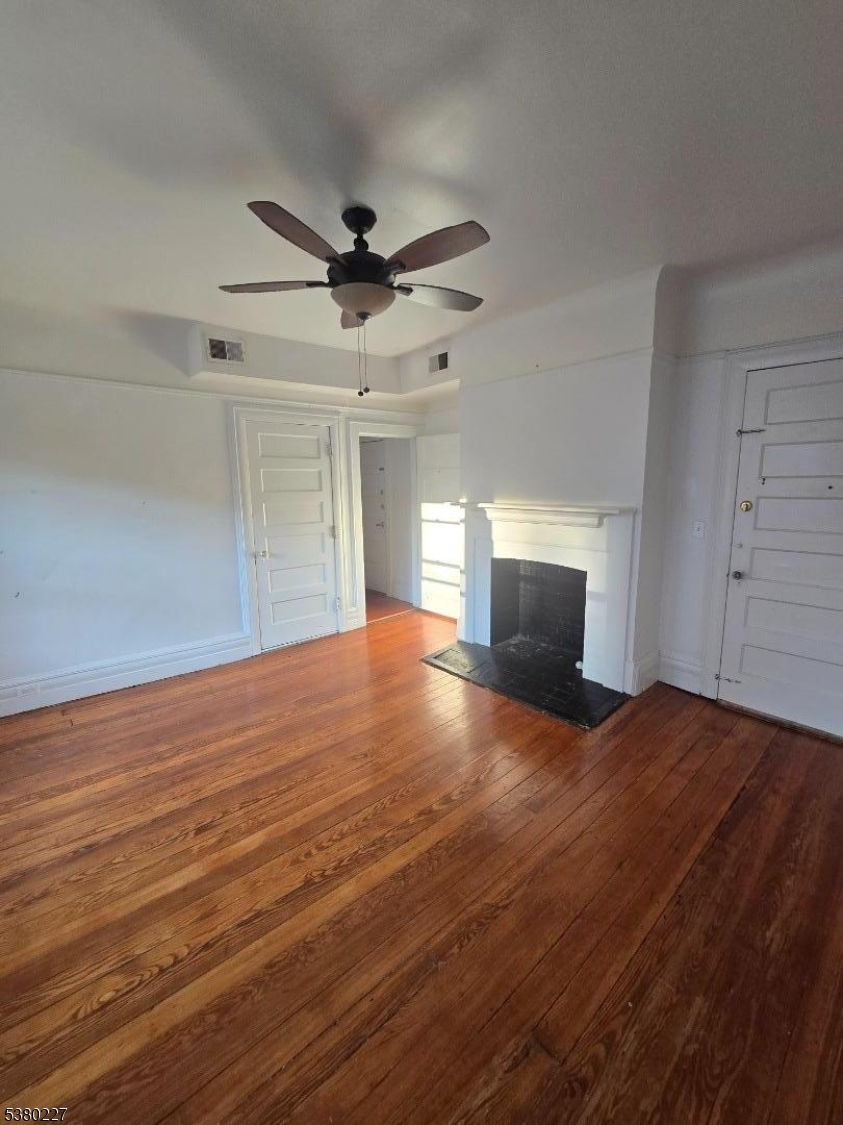 379-387 Mt Prospect Avenue, Unit 4 Newark, NJ 07104 - Photo 21 of 21 a view of empty room with wooden floor and fireplace
