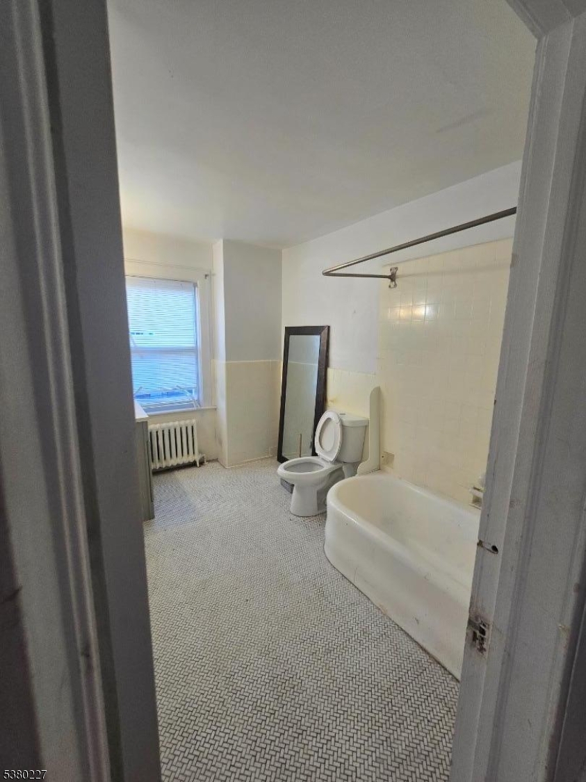 379-387 Mt Prospect Avenue, Unit 4 Newark, NJ 07104 - Photo 9 of 21 a bathroom with a sink toilet and shower