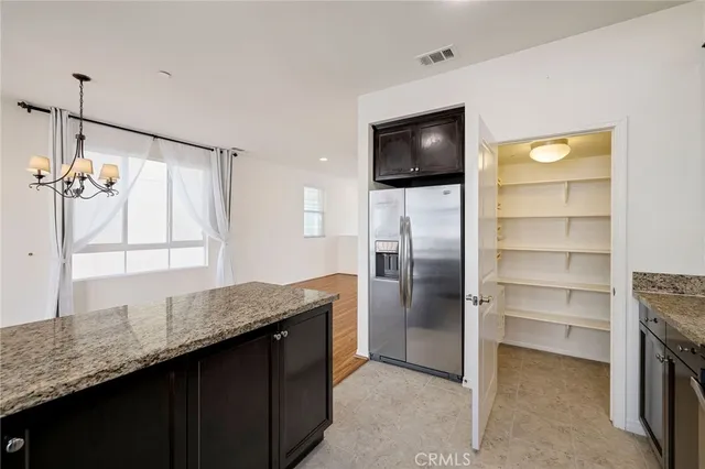 a kitchen with a refrigerator and a sink