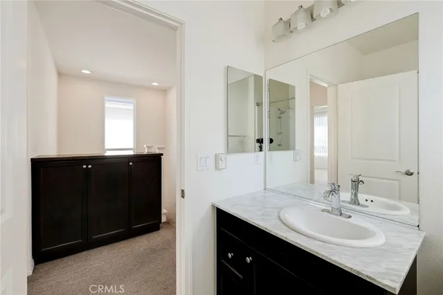 an empty room with closet and a ceiling fan