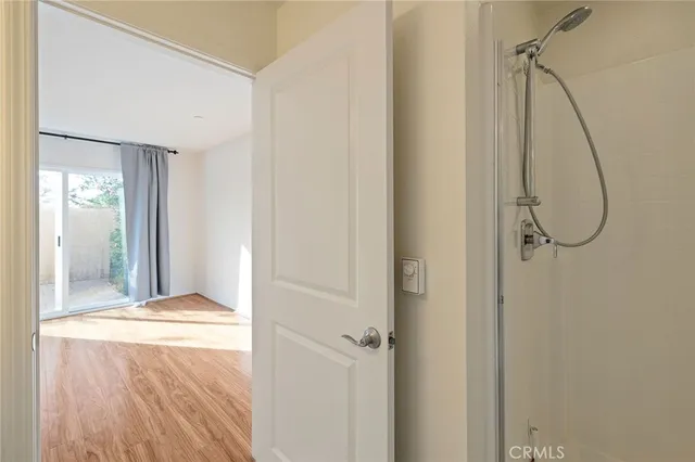 a view of a room with wooden floor and bathroom
