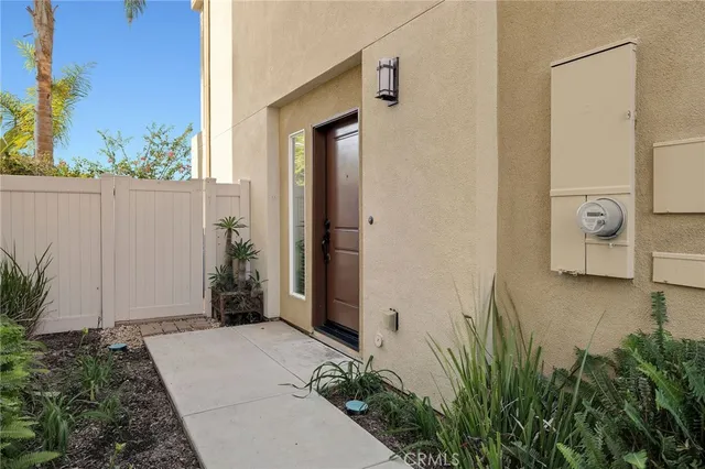 a house with potted plants in front of door