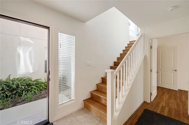 a view of entryway with wooden floor and stairs