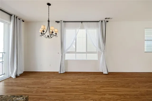 a view of room with window and wooden floor