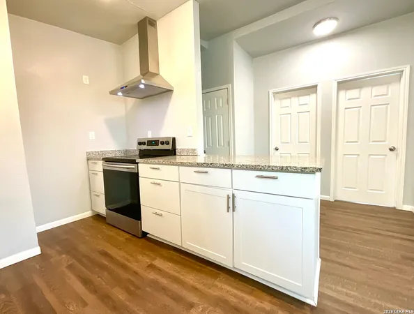 a kitchen with stainless steel appliances granite countertop a stove and a sink