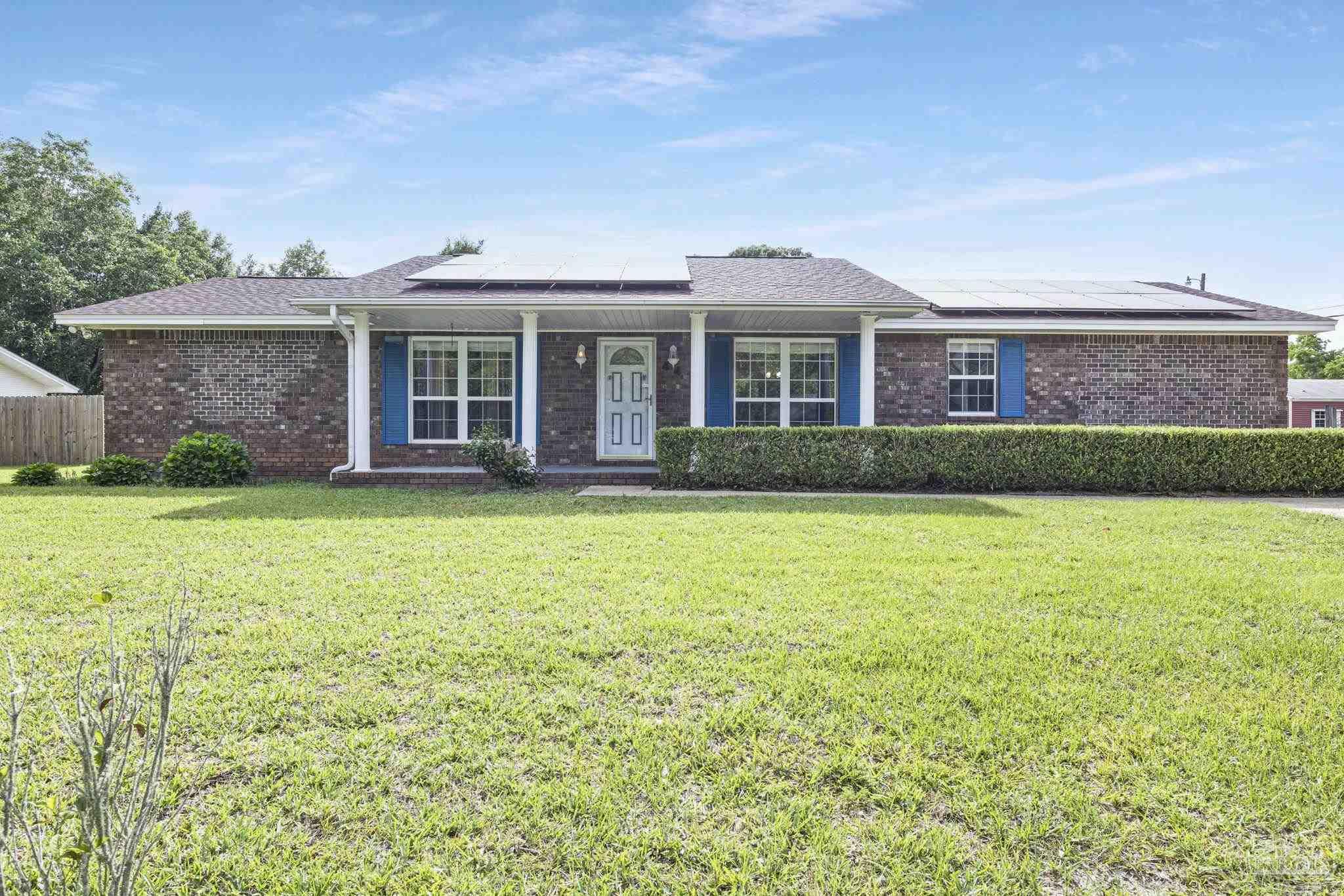 4411 Pace Lane Pace, FL 32571 - Photo 5 of 68 a front view of a house with garden