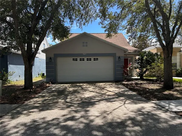 a backyard of a house with large trees