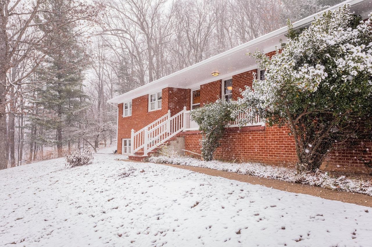 a pathway of a house with a yard covered in snow
