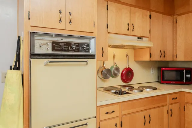 a kitchen with a stove and a white refrigerator