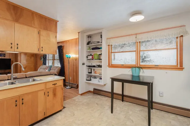 a kitchen with cabinets appliances and a window