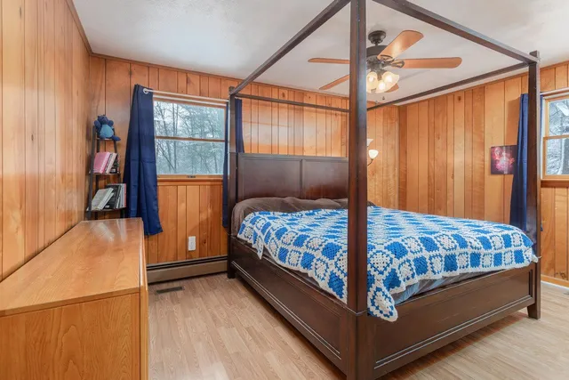 a bed sitting in a bedroom next to a window