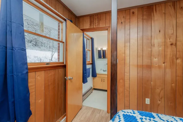 a view of bathroom with a door and mirror