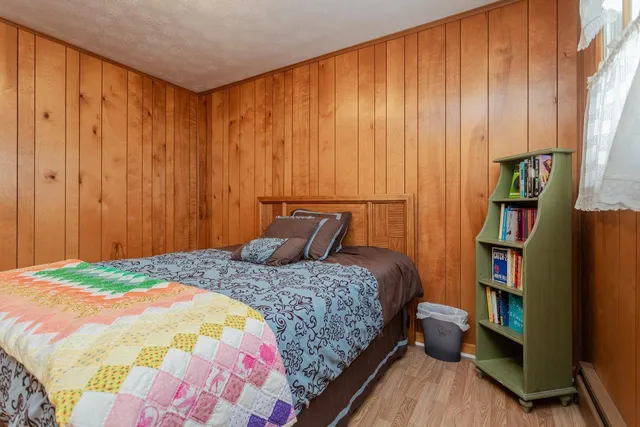 a bedroom with a bed and a bookshelf