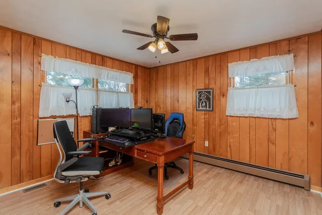a work room with furniture and wooden floor