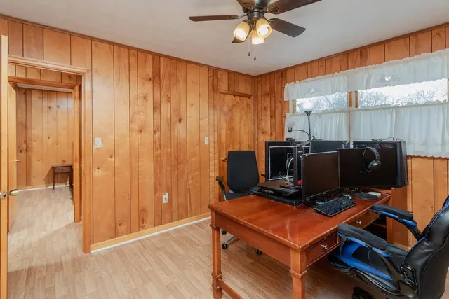 a view of workspace with wooden floor windows