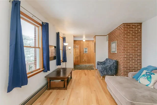 a bedroom with furniture and a large window