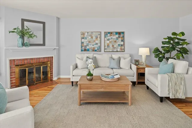a living room with furniture and a fireplace