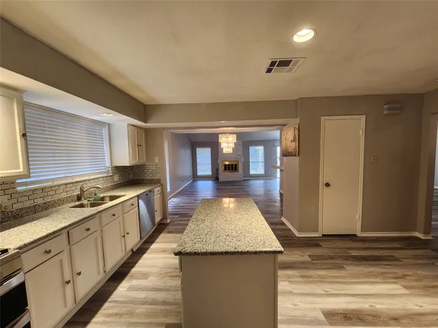 a view of a kitchen counter top space and stainless steel appliances
