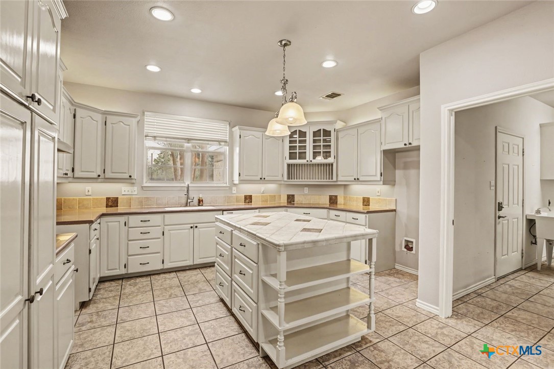 307 West Main Street Stockdale, TX 78160 - Photo 16 of 36 a kitchen with a stove a sink and a refrigerator