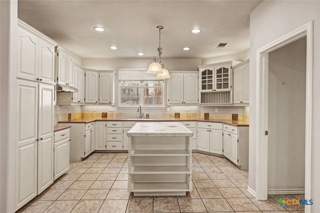 307 West Main Street Stockdale, TX 78160 - Photo 19 of 36 a kitchen with white cabinets and white appliances