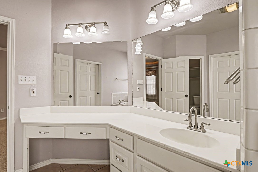 307 West Main Street Stockdale, TX 78160 - Photo 25 of 36 a bathroom with a sink vanity and a mirror