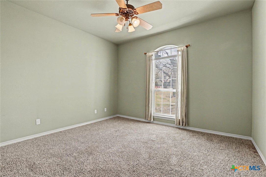 307 West Main Street Stockdale, TX 78160 - Photo 28 of 36 an empty room with windows and fan