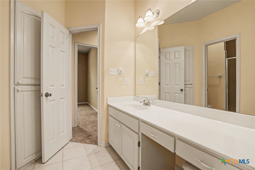 307 West Main Street Stockdale, TX 78160 - Photo 30 of 36 a spacious bathroom with a sink a mirror and a shower