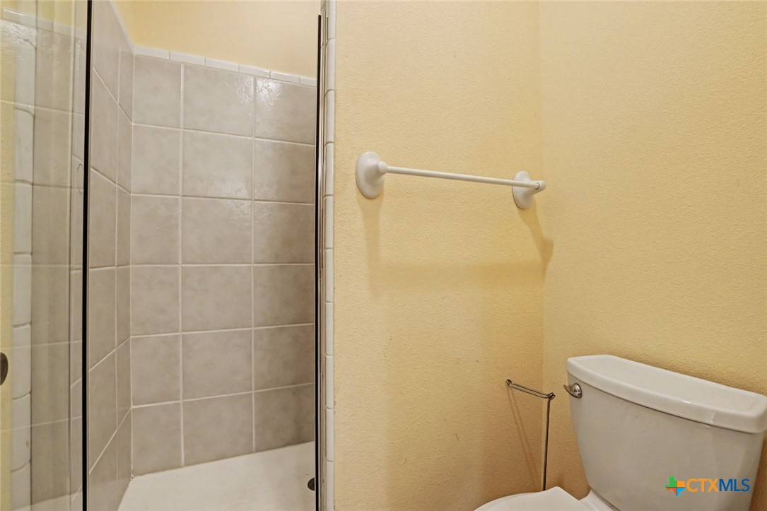 307 West Main Street Stockdale, TX 78160 - Photo 31 of 36 a bathroom with a shower and a toilet