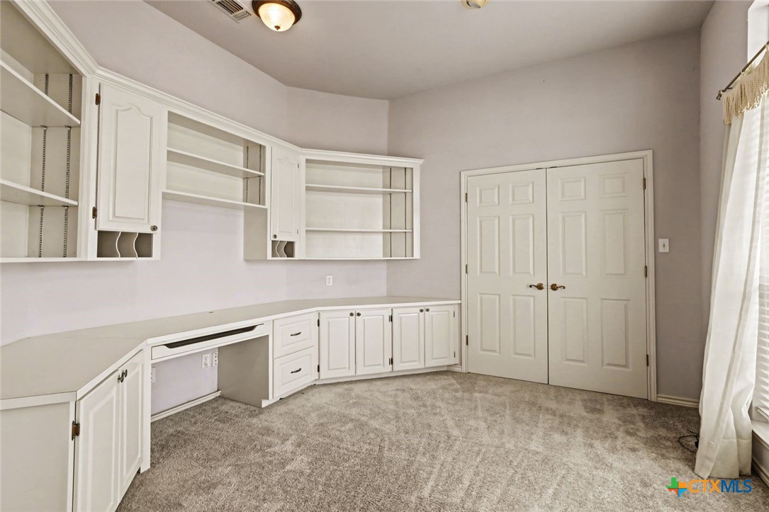 307 West Main Street Stockdale, TX 78160 - Photo 32 of 36 a view of a kitchen with white cabinets and wooden floor