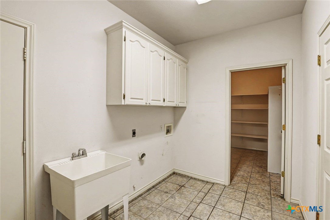 307 West Main Street Stockdale, TX 78160 - Photo 34 of 36 a bathroom with a sink a toilet and vanity