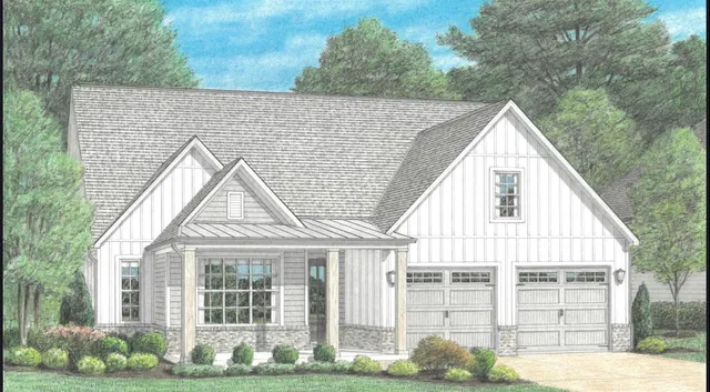 a view of a white house next to a yard