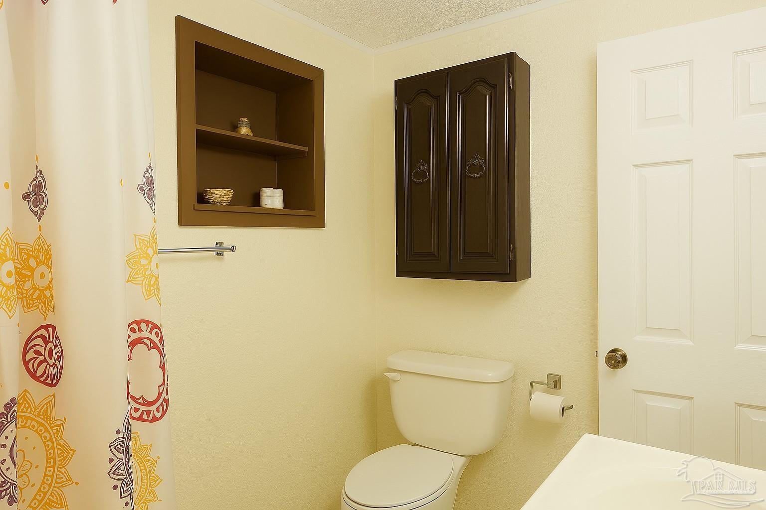 6274 Munson Highway Milton, FL 32570 - Photo 17 of 26 a bathroom with a toilet and a sink
