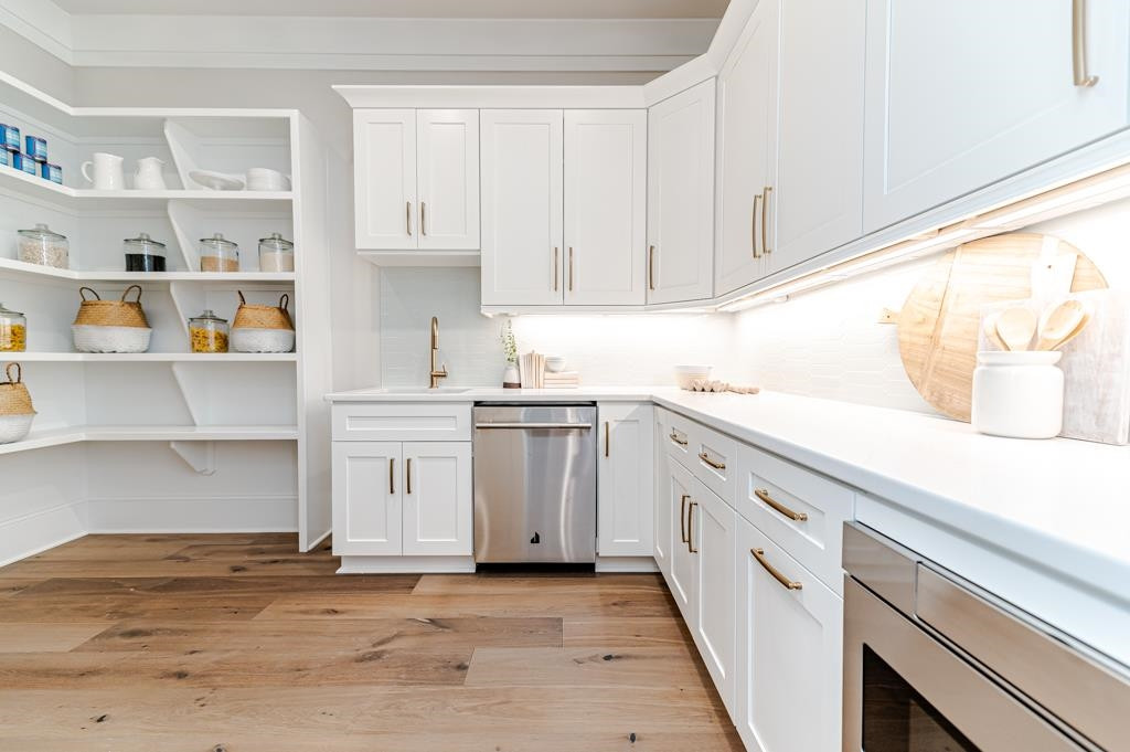 7317 Grist Mill Road Raleigh, NC 27615 - Photo 43 of 89 a kitchen with white cabinets and white appliances