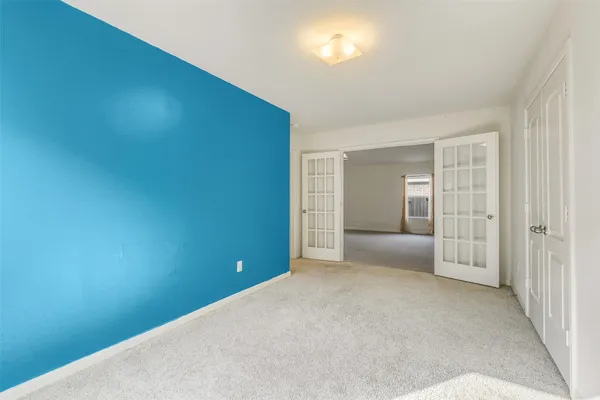 an empty room with floor to ceiling window