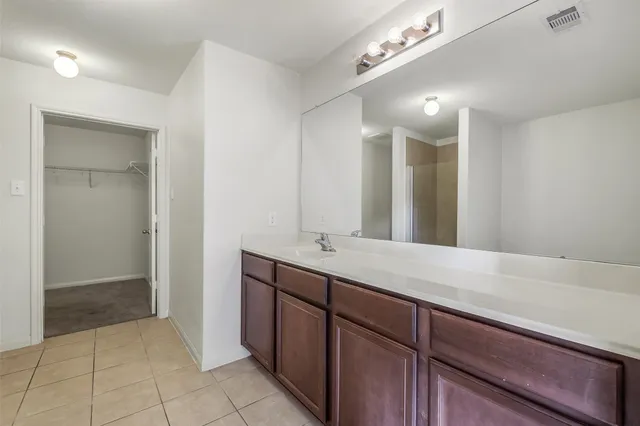 a white bath tub sitting next to a shower