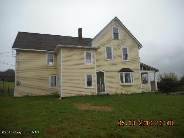 233 Perkins Pond Road Beach Lake, PA 18405 - Photo 1 of 20 a front view of a house with a garden