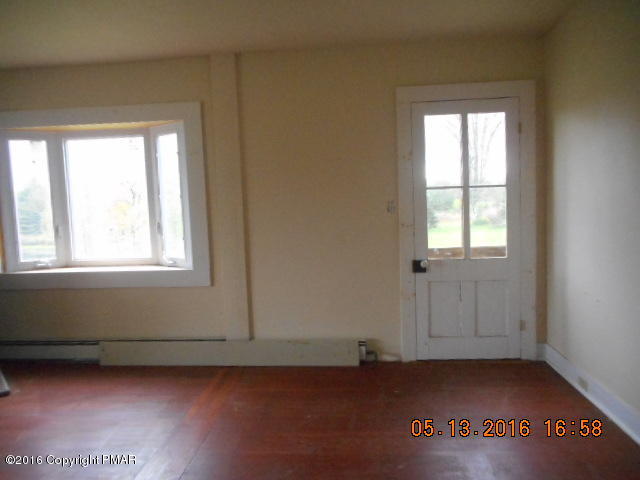 233 Perkins Pond Road Beach Lake, PA 18405 - Photo 16 of 20 an empty room with wooden floor and windows