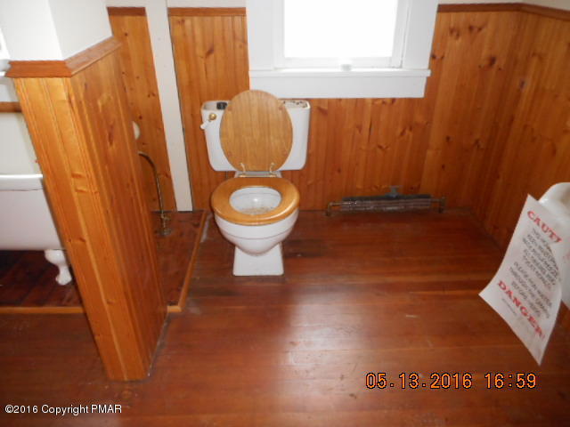 233 Perkins Pond Road Beach Lake, PA 18405 - Photo 18 of 20 a bathroom with a toilet and a shower curtain