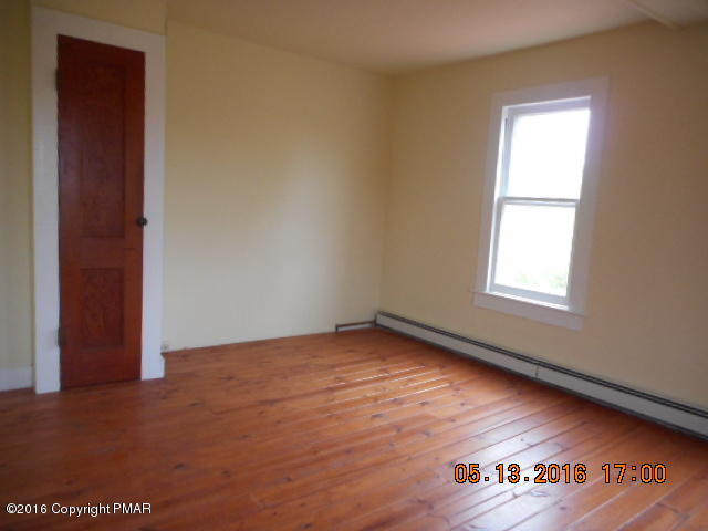 233 Perkins Pond Road Beach Lake, PA 18405 - Photo 20 of 20 a view of an empty room with wooden floor and a window