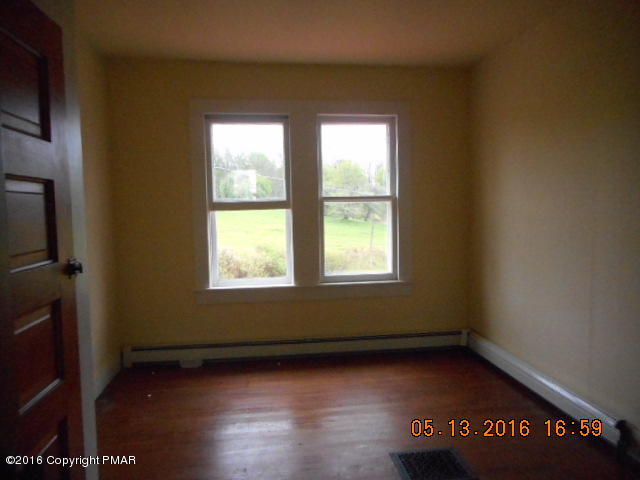 233 Perkins Pond Road Beach Lake, PA 18405 - Photo 6 of 20 an empty room with wooden floor and windows