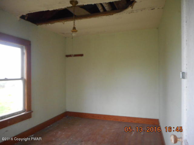233 Perkins Pond Road Beach Lake, PA 18405 - Photo 8 of 20 an empty room with a window