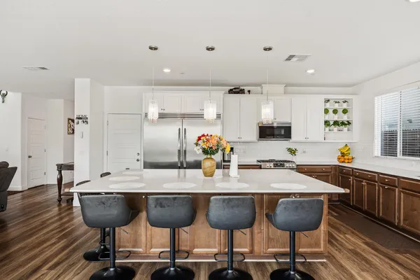 a kitchen with stainless steel appliances kitchen island granite countertop a sink and cabinets
